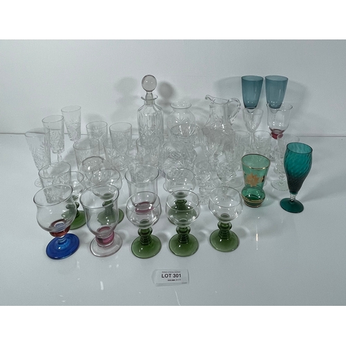 301 - A collection of Glassware including Decanter, jugs and coloured glasses.