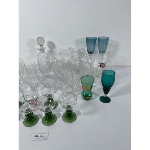 301 - A collection of Glassware including Decanter, jugs and coloured glasses.