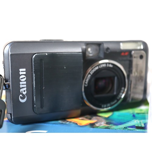 38 - A group of digital cameras including Canon Powershot s110, Fujifilm S5000, Canon Powershot S70, Cano... 