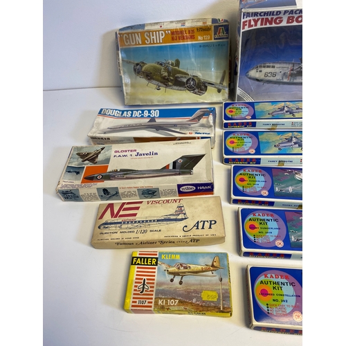 318 - A collection of Model plane kits including Italeri Fairchild Packet C119G Flying Box Car 146, Mitche... 