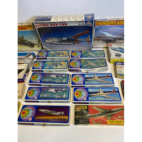 318 - A collection of Model plane kits including Italeri Fairchild Packet C119G Flying Box Car 146, Mitche... 