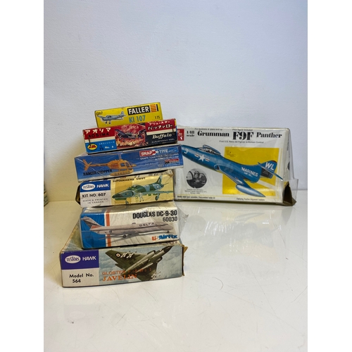 318 - A collection of Model plane kits including Italeri Fairchild Packet C119G Flying Box Car 146, Mitche... 