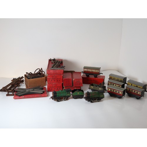 269 - A group of Hornby Tin plate Clock work locomotives , rolling stock, carriages, boxed straight rails,... 