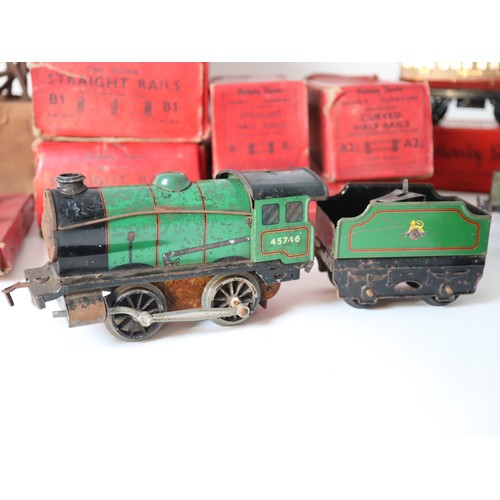 269 - A group of Hornby Tin plate Clock work locomotives , rolling stock, carriages, boxed straight rails,... 