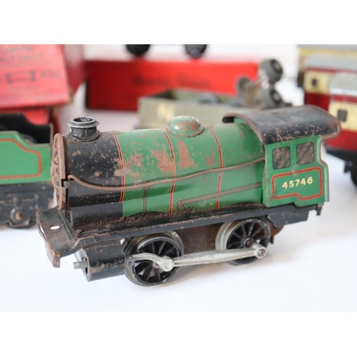 269 - A group of Hornby Tin plate Clock work locomotives , rolling stock, carriages, boxed straight rails,... 