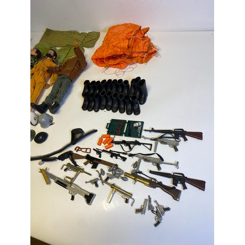 437 - Three Vintage Action Man with a bundle of various accessories including, Guns, Boots, clothes and Pa... 