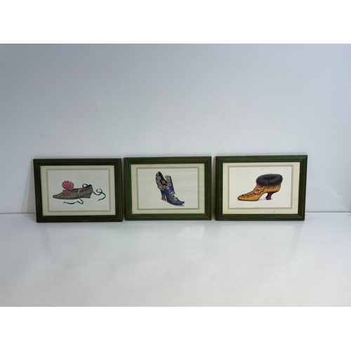Three small framed shoe prints