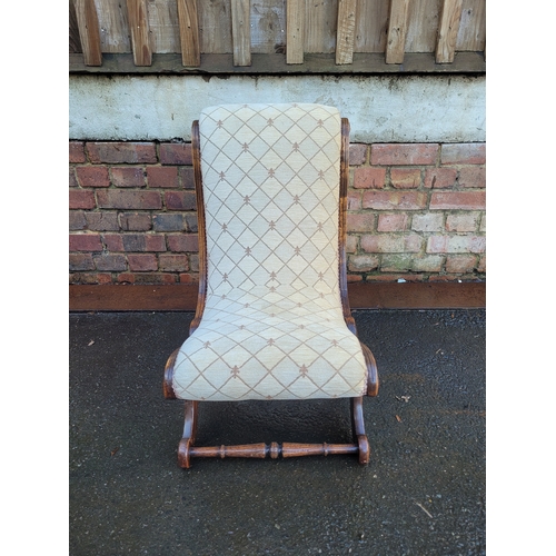 560 - Antique Scrolled Mahogany nursing chair with beige upholstery