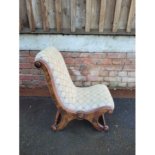 560 - Antique Scrolled Mahogany nursing chair with beige upholstery