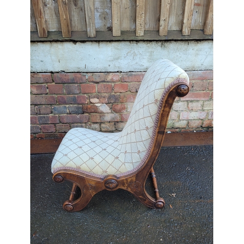 560 - Antique Scrolled Mahogany nursing chair with beige upholstery