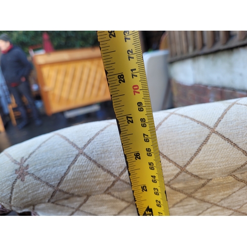 560 - Antique Scrolled Mahogany nursing chair with beige upholstery