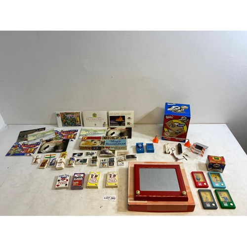 283 - Collection of toys, tea cards, and more