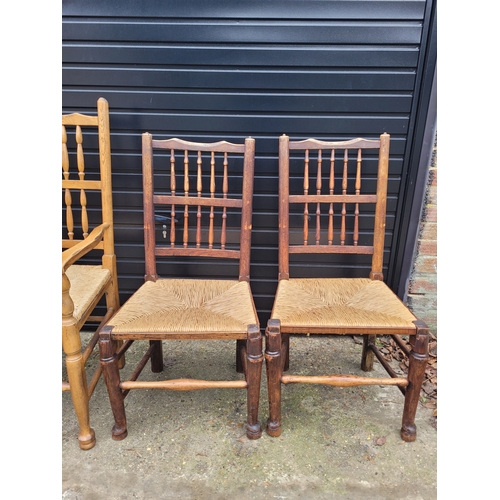696 - Five 19th century Oak spindle back rush chairs and carver + later 20th century carver
