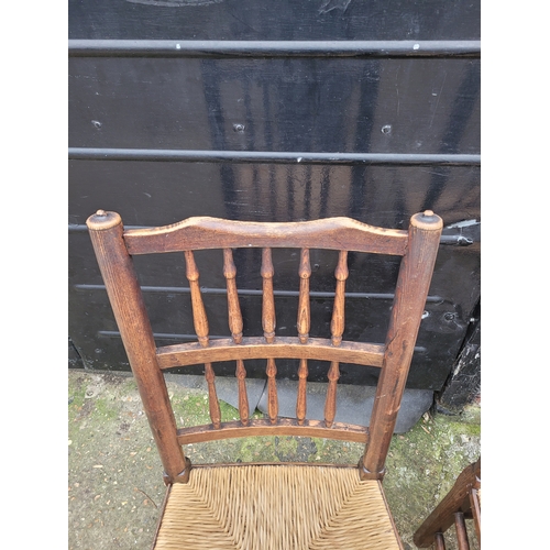 696 - Five 19th century Oak spindle back rush chairs and carver + later 20th century carver