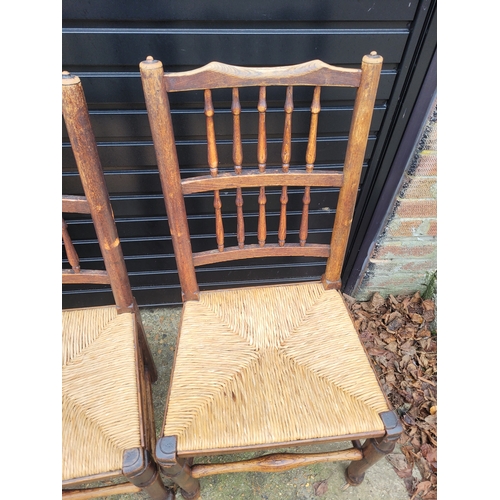 696 - Five 19th century Oak spindle back rush chairs and carver + later 20th century carver