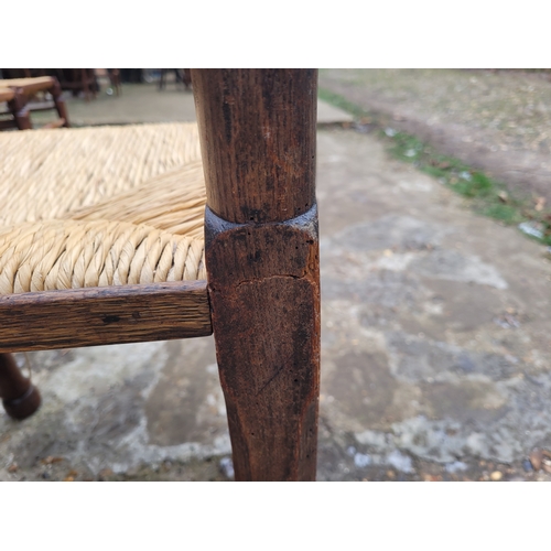 696 - Five 19th century Oak spindle back rush chairs and carver + later 20th century carver