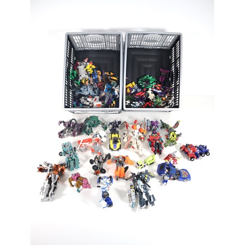 A collection of primarily 2000s Transformers action figures, with a selection of pieces from the 1980s and 1990s. The collection includes Autobots, Decepticons, and a variety of character variants and editions.