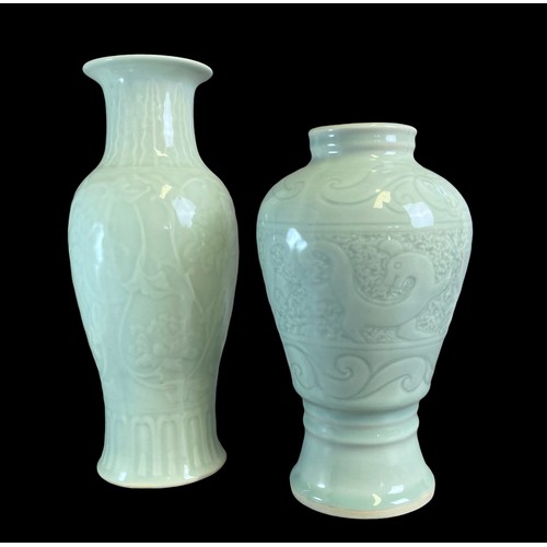 156 - Two Chinese porcelain Celadon Vases.
One decorated with stylised Dragons above scrolling border. The... 