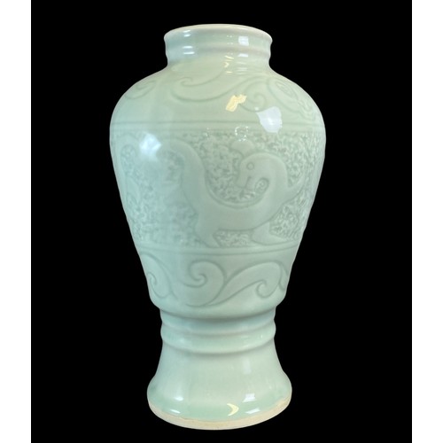 156 - Two Chinese porcelain Celadon Vases.
One decorated with stylised Dragons above scrolling border. The... 