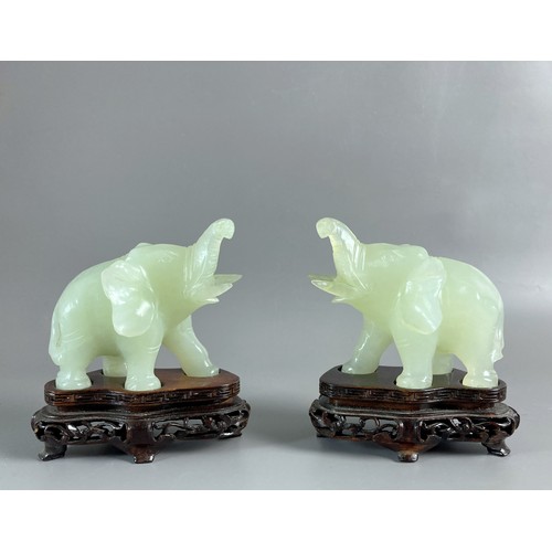 36 - Pair of Chinese carved Jade Elephants on wooden stands. 
11 x 10cm (incl stand)