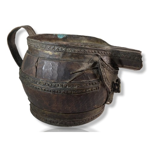 245 - 18th/19th Century Tibetan metal mounted carved Wooden Jug. Applied jewels to front.
18 x 29 cm