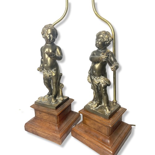 312 - Large pair of Bronze effect Cherub table lamps. Mixed media in a bronze effect with heavy Walnut eff... 