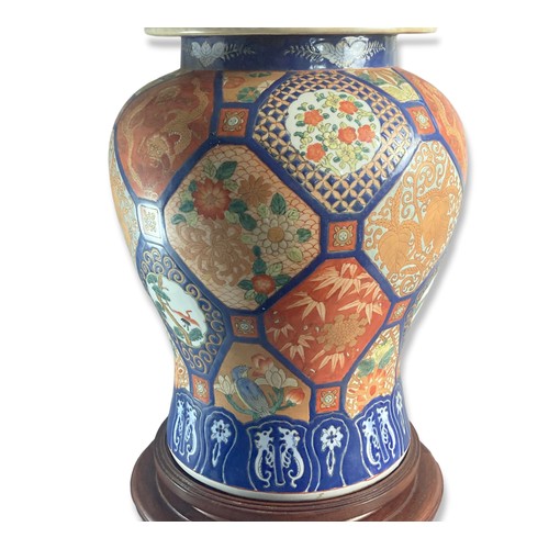 250 - Large hand painted Japanese Imari vase & cover.
On carved wooden base.
Signed to base.