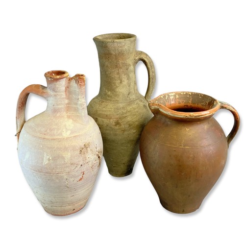 119 - Three large antique Continental pottery Jugs. Including painted Slip Pitcher, A tall Amphora pottery... 