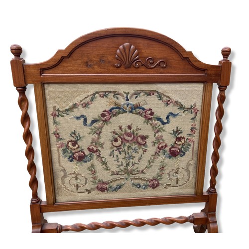 321 - Two early 20th century fire screens including embroidered tapestry with barley twist supports.