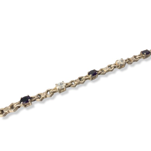 49 - Silver link bracelet with clear & purple coloured stones. Stamped 925.
18cm long.