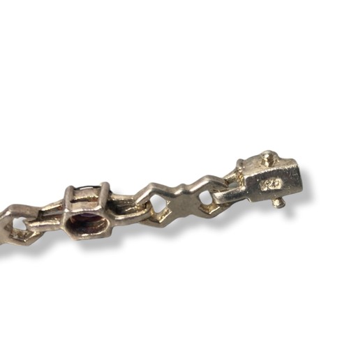 49 - Silver link bracelet with clear & purple coloured stones. Stamped 925.
18cm long.