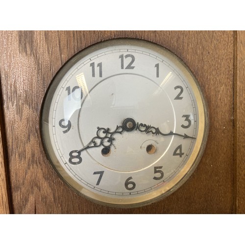 243B - Early 20th century carved Oak wall clock. With Key & pendulum.
73cm Tall