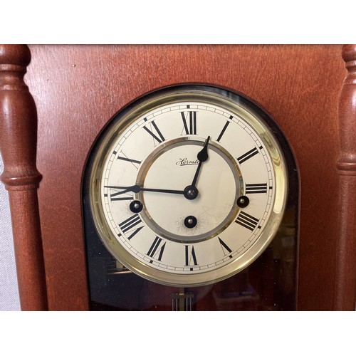 243C - Hermle Walnut effect Pendulum Wall clock.
With key & pendulum.
65cm Tall.