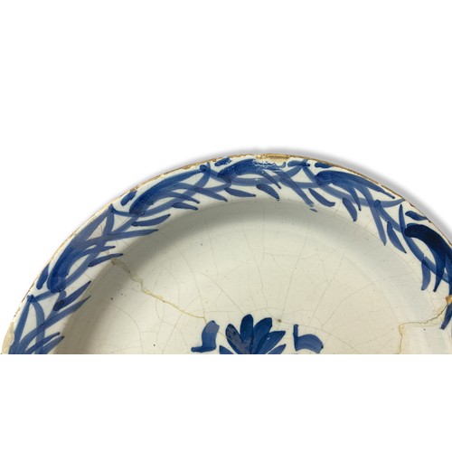 71 - An 18th-century Delft ware plate. Central floral motif with similar border pattern.  Repaired.
22cm ... 