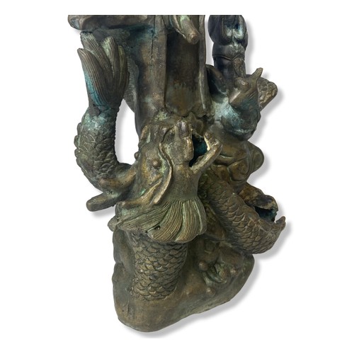 121 - A Chinese cast metal Guanyin stood on a Dragon statue.
32cm Tall