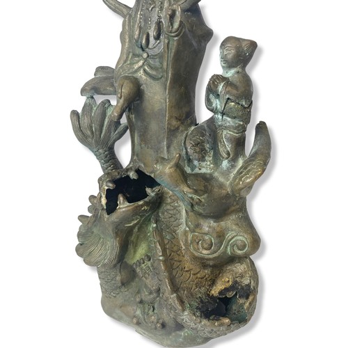 121 - A Chinese cast metal Guanyin stood on a Dragon statue.
32cm Tall