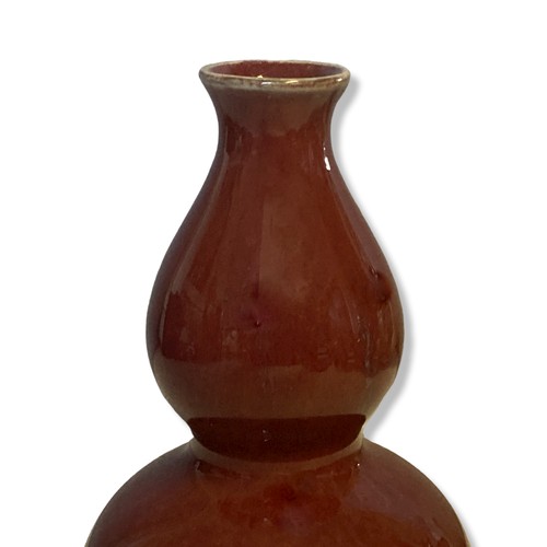 205 - A Chinese Sang-de-Boeuf double gourd shape vase.  
17.5cm Tall