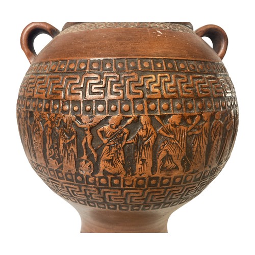 76 - A Greek Terracotta Urn. Decorated with a band of classical scenes between Greek key pattern.
20cm Ta... 