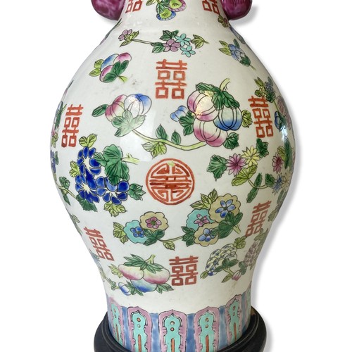 211 - A large Chinese hand painted vase. Painted with Fruits and Buddhistic symbols. Figural handles. 
45.... 