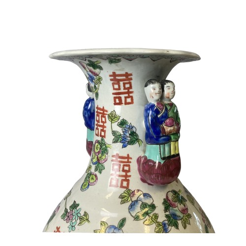 211 - A large Chinese hand painted vase. Painted with Fruits and Buddhistic symbols. Figural handles. 
45.... 