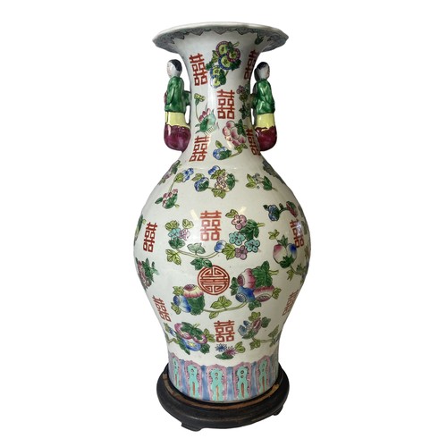 211 - A large Chinese hand painted vase. Painted with Fruits and Buddhistic symbols. Figural handles. 
45.... 