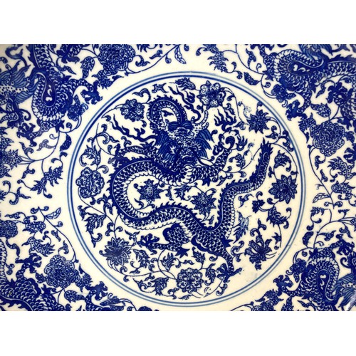 221 - A large Chinese porcelain 5-claw Dragon dish. Depicting a central Dragon amongst blossoming out-crop... 