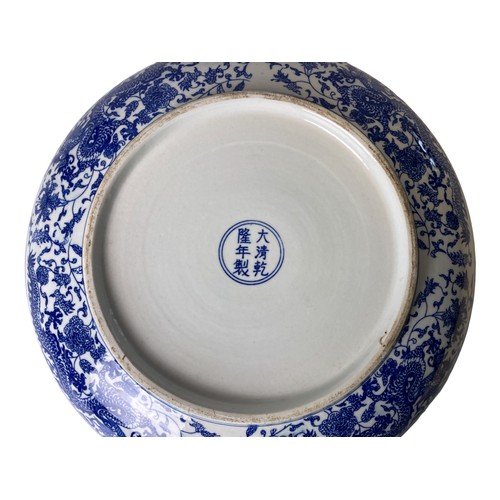 221 - A large Chinese porcelain 5-claw Dragon dish. Depicting a central Dragon amongst blossoming out-crop... 