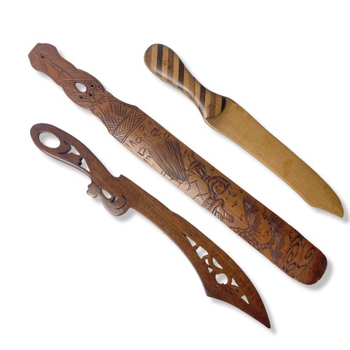 64 - A Collection of carved wooden paper knives and Page turners.
Longest - 36cm