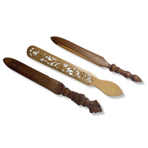 64 - A Collection of carved wooden paper knives and Page turners.
Longest - 36cm