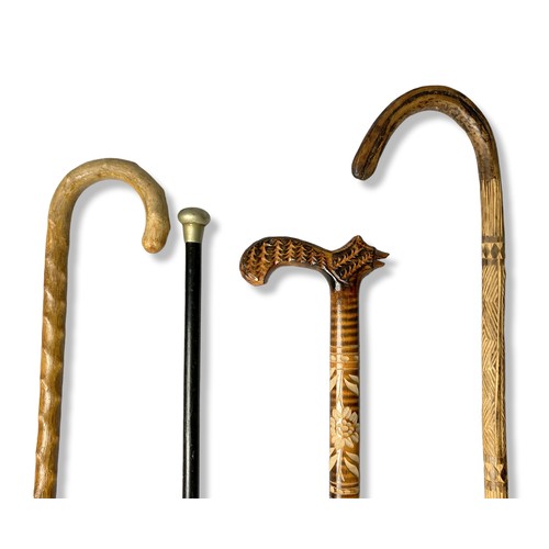 68 - Four vintage walking sticks and canes.