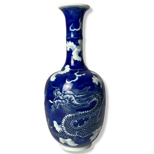 225 - A Chinese blue & white porcelain bottle vase. 'Cracked Ice' ground with a hand painted 5-claw Dragon... 