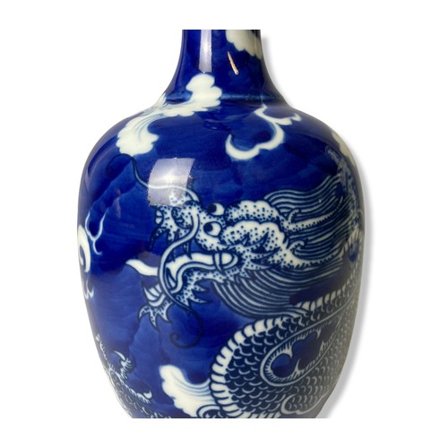 225 - A Chinese blue & white porcelain bottle vase. 'Cracked Ice' ground with a hand painted 5-claw Dragon... 