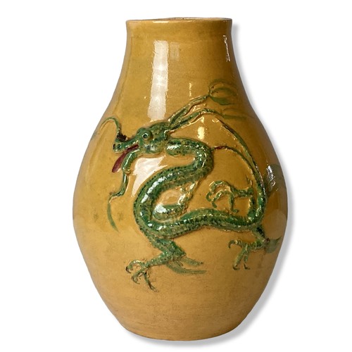 105 - A yellow ground Pottery vase with relief decorated Dragon. 
22cm Tall