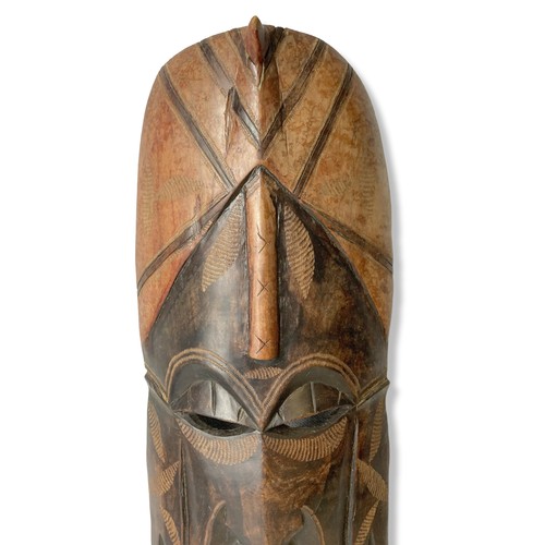 349 - A large carved wooden African tribal mask. 
58cm tall